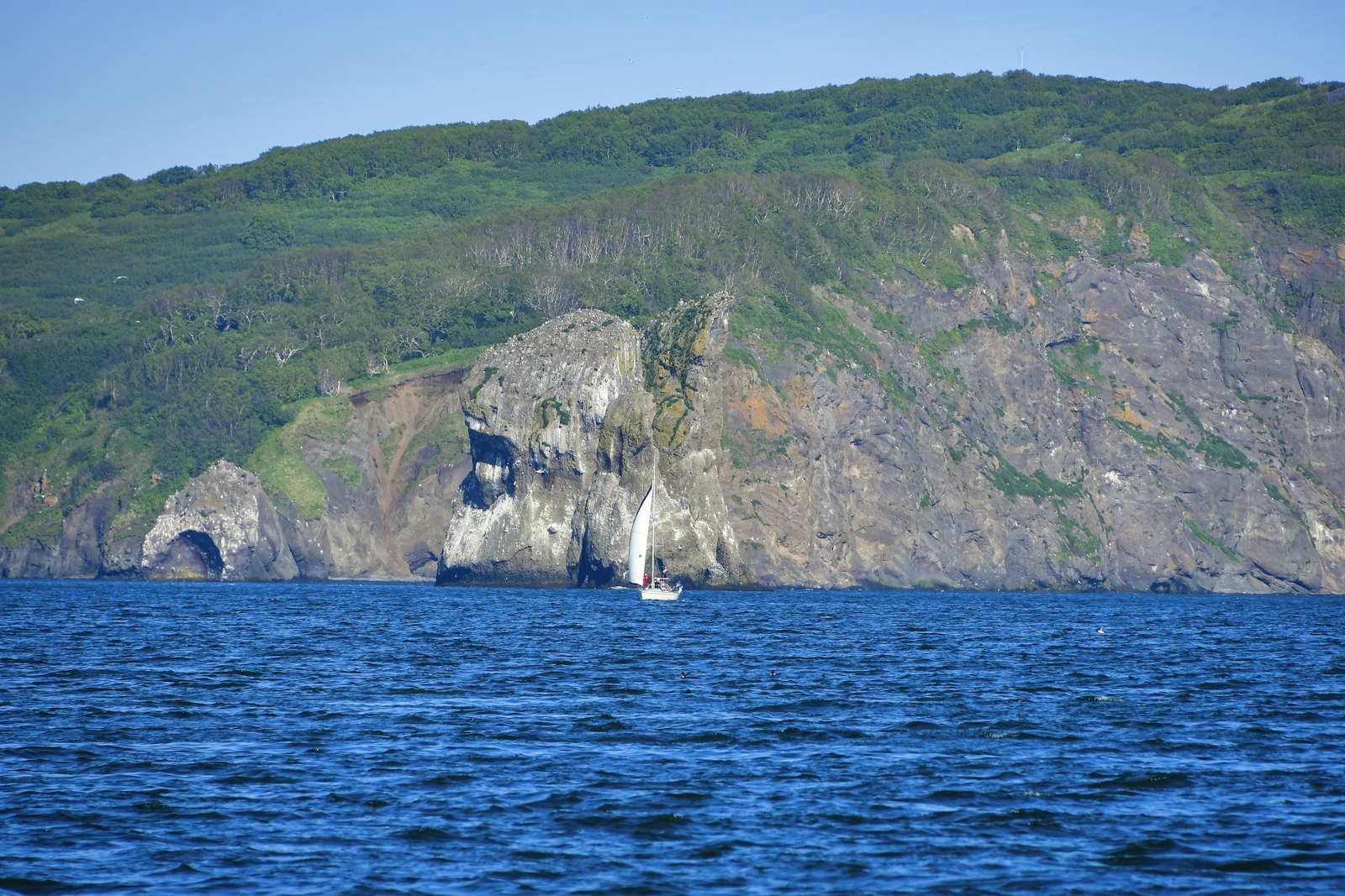 a boat in a body of water near a mountain